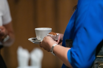 Image showing Close-up photo of a business woman holding a cup of fresh coffee