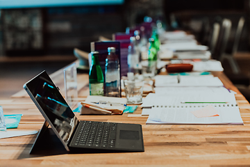 Image showing A laptop on the table of a large seminar hall