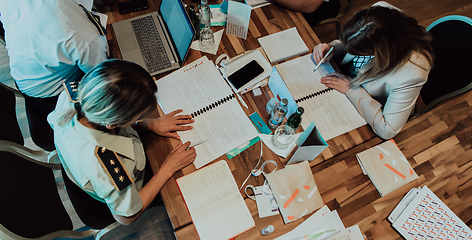 Image showing Top view of colleagues sorting out paperwork together. Businessman working with documentation