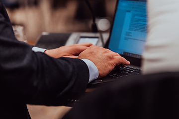 Image showing Close up photo of a businessman typing on a laptop