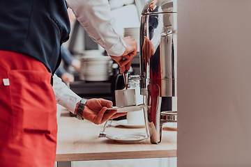 Image showing The waiter preparing coffee for hotel guests. Close up photo of service in modern hotels