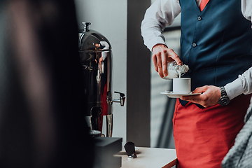 Image showing The waiter preparing coffee for hotel guests. Close up photo of service in modern hotels