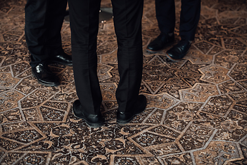 Image showing Close up photo of male businessmen in suits talking