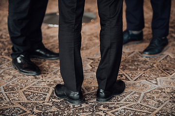 Image showing Close up photo of male businessmen in suits talking