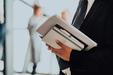 Image showing Cose up photo of a womans hand holding business documents