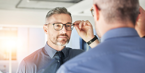 Image showing Mirror reflection, optometry and man with glasses for eye care, vision and choice of frame. Mature, store and person eyewear shopping for a lens or fit for eyeglasses style in a shop with a decision