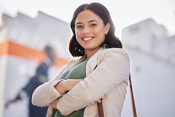 Image showing Business woman, arms crossed and portrait outdoor in city with travel and smile. Urban, face and female professional with bag for career and commute to work feeling happy and proud from confidence