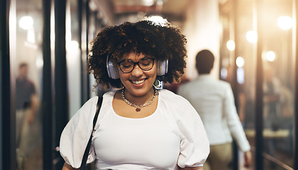 Image showing Headphones, happy and face of a woman in the office walking with her colleagues to her desk. Greeting, smile and portrait of a female creative designer listening to music, radio or song in workplace.