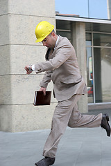 Image showing A businessman panic running 