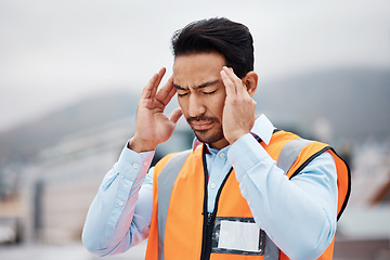 Image showing Stress, headache and male construction worker on a rooftop of a building for inspection or maintenance. Migraine, burnout and young man engineering industry worker working in an urban town on site.