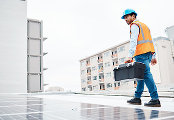 Image showing Solar panel, tool box and engineering with man on roof top for renewable energy, project or power. Construction, electricity or technician with contractor in city for inspection and photovoltaic grid