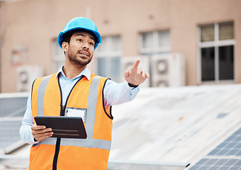 Image showing Tablet, planning and male construction worker on a rooftop of a building for inspection or maintenance. Industry, engineering and young man foreman with digital technology working in an urban town.