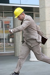 Image showing A businessman panic running 