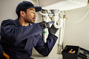 Image showing Plumbing, pipes and maintenance with man in kitchen for repair, industrial and inspection. Handyman, tools and safety with male plumber fixing sink for home improvement, drainage and water system