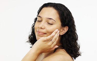 Image showing Face, makeup and skincare with a woman in studio isolated on a white background touching her skin. Portrait, beauty and facial with an attractive young female rubbing her cheek for natural treatment