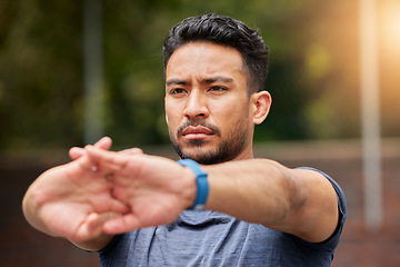 Image showing Serious, fitness or man stretching arms in exercise, training or healthy sports outdoor. Face of strong asian athlete focus to warm up in workout, performance or thinking of mobility, energy or power