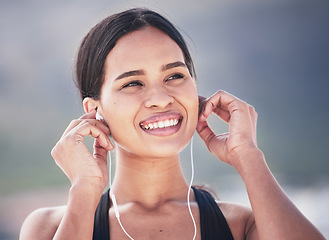 Image showing Fitness, smile and woman with music earphones outdoor for running, training and sports routine on blurred background. Exercise, podcast and happy female runner with radio, track and audio motivation