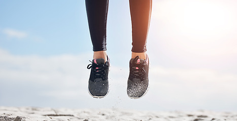 Image showing Woman, fitness and shoes in jump on mockup for sports motivation, running or outdoor exercise. Closeup of female person, athlete or runner feet jumping in workout for healthy wellness or training