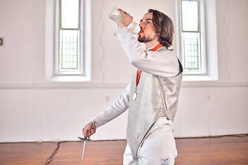 Image showing Fencing, sports and man drinking water after training, fitness or workout with sword in club. Bottle, fencer or athlete with beverage after exercise with liquid for nutrition, body health or wellness