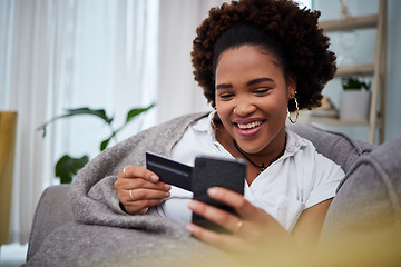 Image showing Happy black woman, phone and credit card for ecommerce, payment or fintech banking on sofa at home. African female person or debit shopper on mobile smartphone app in online shopping, purchase or buy