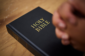 Image showing Bible, hands and woman in prayer in home, lounge and reading book of faith, religion and worship study for mindfulness. Person, praying and studying holy book for peace, praise and meditation