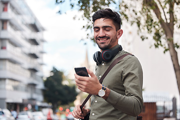 Image showing Travel, city and man with a phone outdoor for communication, connection or chat. Happy male student on urban street with smartphone and network for reading social media or navigation app notification