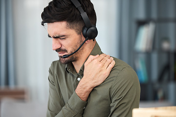 Image showing Call center man, shoulder pain and stress in office, communication expert or consultant with emergency. Young telemarketing agent, crm and muscle injury with accident, problem or fatigue in workplace