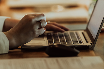 Image showing Close up photo of a woman's hand typing on a laptop at a seminar