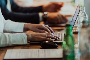 Image showing Close up photo of a woman's hand typing on a laptop at a seminar