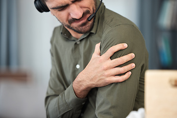 Image showing Call center man, shoulder pain and muscle in office, communication expert or consultant with burnout. Young telemarketing agent, crm and stress injury with accident, problem or fatigue in workplace