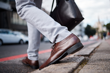 Image showing Feet, business man and walking on city road or ground for travel, journey and commute to work. Shoes, legs and closeup of a professional person or employee crossing an urban street with a bag