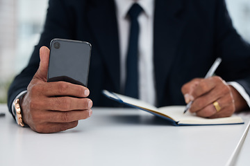 Image showing Table, hands and businessman with phone and notebook for planning, schedule or work agenda. Office, writing and a corporate employee with a planner and a mobile for an app while working on a reminder