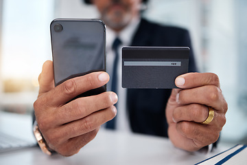 Image showing Hands, phone and credit card man in office for payment, ecommerce or budget for shopping in call center. Consultant, crm and banking in closeup for loan, fintech or bills in telemarketing workplace