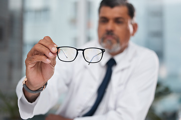 Image showing Hands, man and optician with glasses for vision, eyesight and medical eye care of prescription lens. Closeup of optometrist show frame for eyewear, test or consulting for optical assessment in clinic