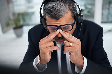 Image showing Depressed, tired and man in a call center with a headache from telemarketing or technical support. Sad, fail or a mature customer service employee or boss with a mistake or anxiety with communication