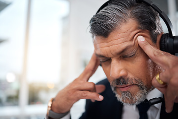 Image showing Stress, call center and face of man in customer service agency with pain, burnout or anxiety. Headache, frustrated and tired salesman consulting with challenge, client problem and fatigue for mistake