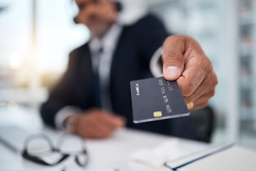 Image showing Hand, giving credit card and man in office for payment, ecommerce or budget for shopping in call center. Consultant, crm and banking in closeup for loan, account or bills in telemarketing workplace