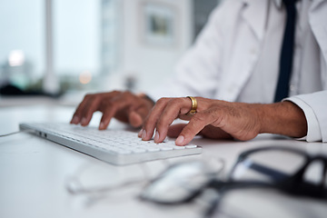 Image showing Hands, keyboard and doctor typing at desk for research, healthcare and telehealth on internet in hospital. Computer, fingers and medical professional writing email, planning and work online in clinic