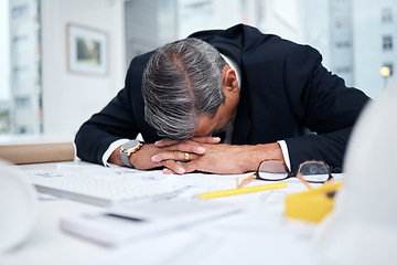 Image showing Tired, exhausted and architect man in an office with a design problem, mistake or deadline for project. Mature male engineer sleeping at desk with fatigue, burnout or crisis in construction industry