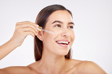 Image showing Facial skincare, smile and woman with a serum, cosmetics or happiness on a white studio background. Female person, model or girl with essential oil, retinol product or dermatology with natural beauty