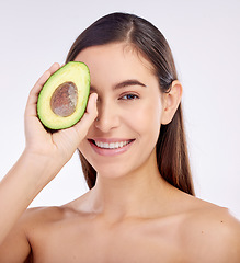 Image showing Face, skincare and happy woman with avocado for beauty isolated on a white background in studio. Portrait, smile and natural model with fruit food for nutrition, healthy diet or omega 3 for wellness