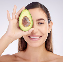 Image showing Face, skincare and woman smile with avocado for beauty cosmetics isolated on a white background in studio. Portrait, happy and natural model with fruit food for nutrition, healthy diet or wellness