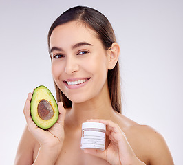 Image showing Skincare, portrait and a woman with avocado or cream on a studio background for dermatology wellness. Happy, health and a young girl or model advertising a food or detox facial product for beauty