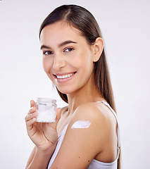 Image showing Body, skincare and woman with cream jar isolated on a white background in studio. Portrait, happy and model with sunscreen on shoulder, natural cosmetics or lotion for beauty, dermatology and health