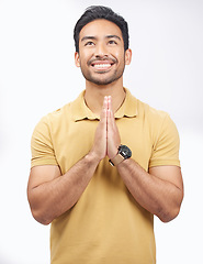 Image showing Man, praying hands and studio with looking up, smile and communication with God by white background. Student, prayer and mindfulness with religion, gratitude and trust for peace, hope and meditation