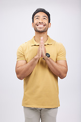 Image showing Man, prayer hands and studio with looking up, smile and communication with God by white background. Student, praying and mindfulness with religion, gratitude and worship for peace, hope or meditation