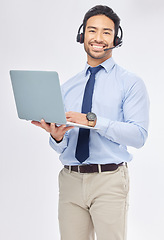 Image showing Laptop, call center and Asian man in portrait for customer service, crm support or contact us isolated on a white studio background. Computer, smile and sales agent, happy consultant or telemarketing