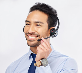 Image showing Call center, happy and Asian man with microphone for telemarketing, crm support and isolated on a white studio background. Thinking, smile and sales agent or consultant listening for customer service