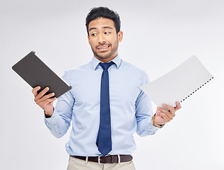 Image showing Choice of print vs digital by businessman with paperwork for corporate work isolated in a studio white background. Tablet, decision and professional with document feeling confused and with question