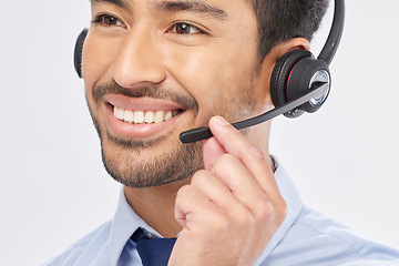 Image showing Face, smile and headset with a call center man in studio on a white background for customer service or support. Contact us, crm and consulting with a happy male employee talking for assistance